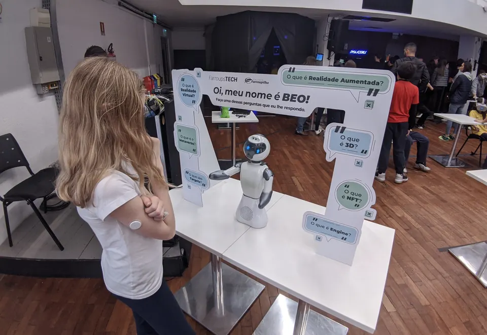 Student talking with Beo at a school event