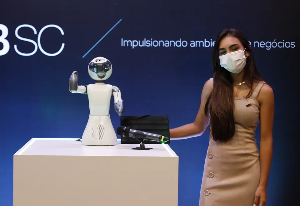 Beo waving next to a host at a corporate event